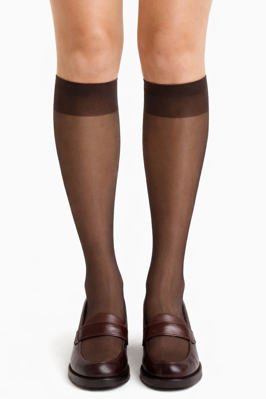 Brown knee-high socks worn with brown shoes on a white background