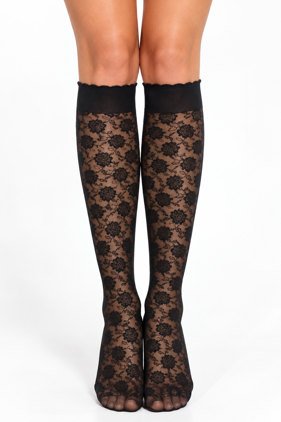 Black lace knee-high socks with a floral pattern and scalloped top band, shown on a model's legs against a white background.