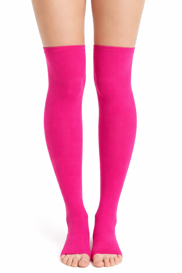 Person wearing bright pink high-waisted shorts and matching thigh-high socks on a white background