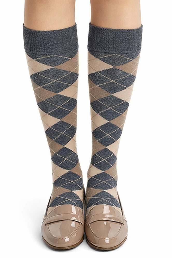 Knee-high argyle patterned socks with beige shoes on a white background