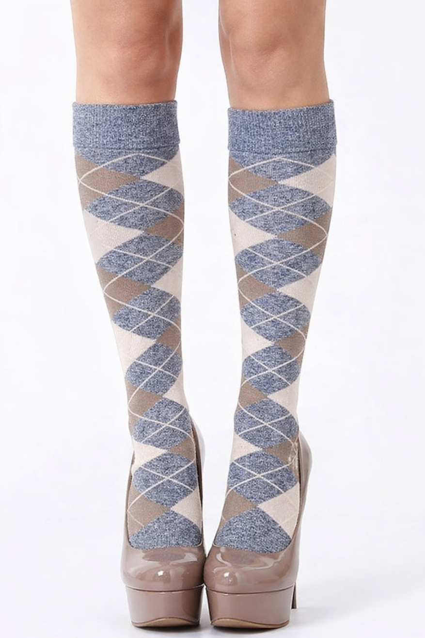 Patterned knee-high socks with platform shoes on a white background