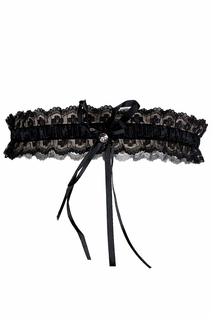 Black lace garter with a bow on a white background