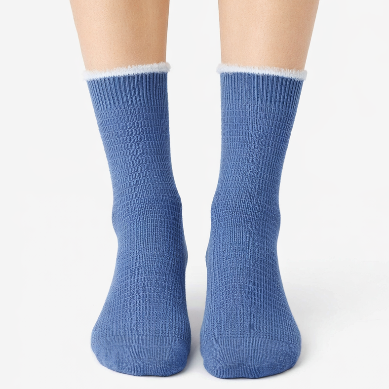 Blue socks with white trim worn by a person on a white background
