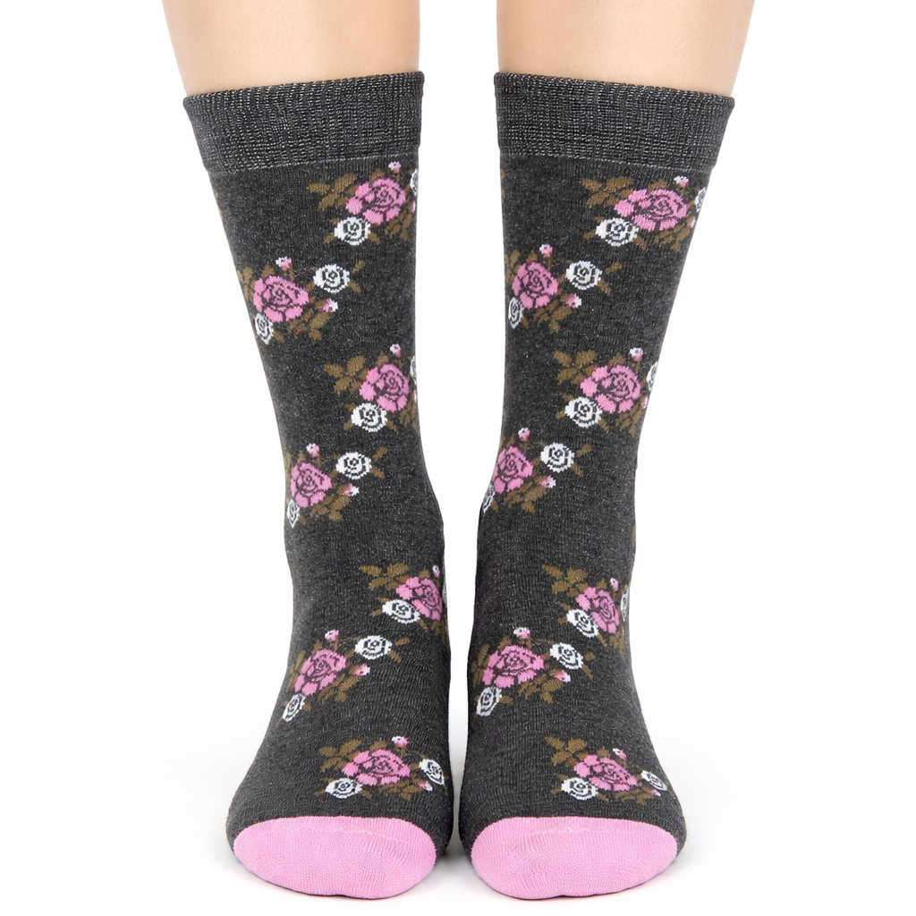 Dark gray socks with floral patterns and pink toes worn by a person on a white background