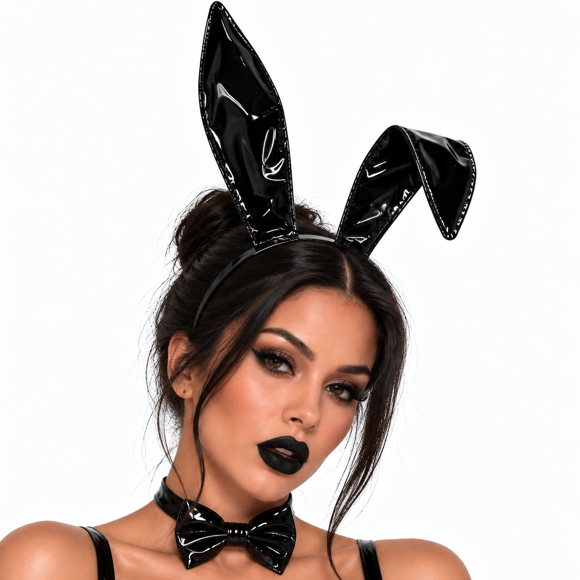 A woman wearing a glossy black patent bunny headband with upright ears and a matching black bow tie against a plain white background.