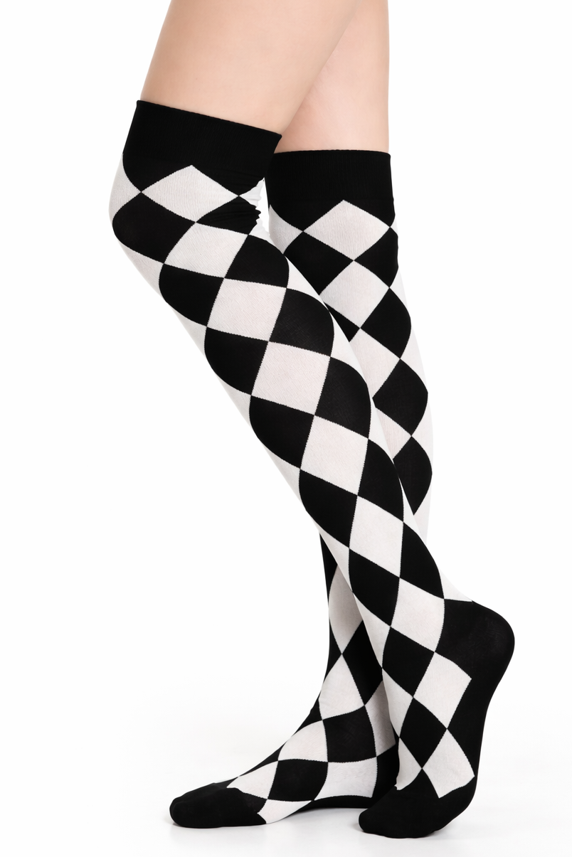 Side view of a model’s legs from mid-thigh down wearing black-and-white harlequin diamond knee-high socks on a white background, no shoes.