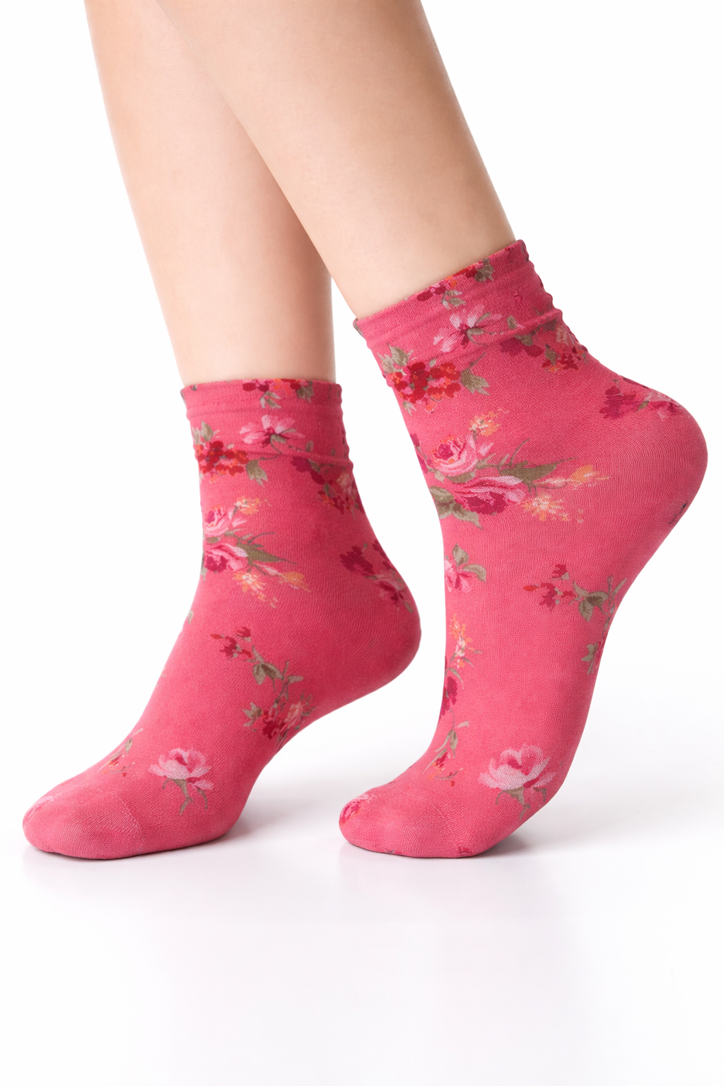 Pink floral socks worn by a person on a white background