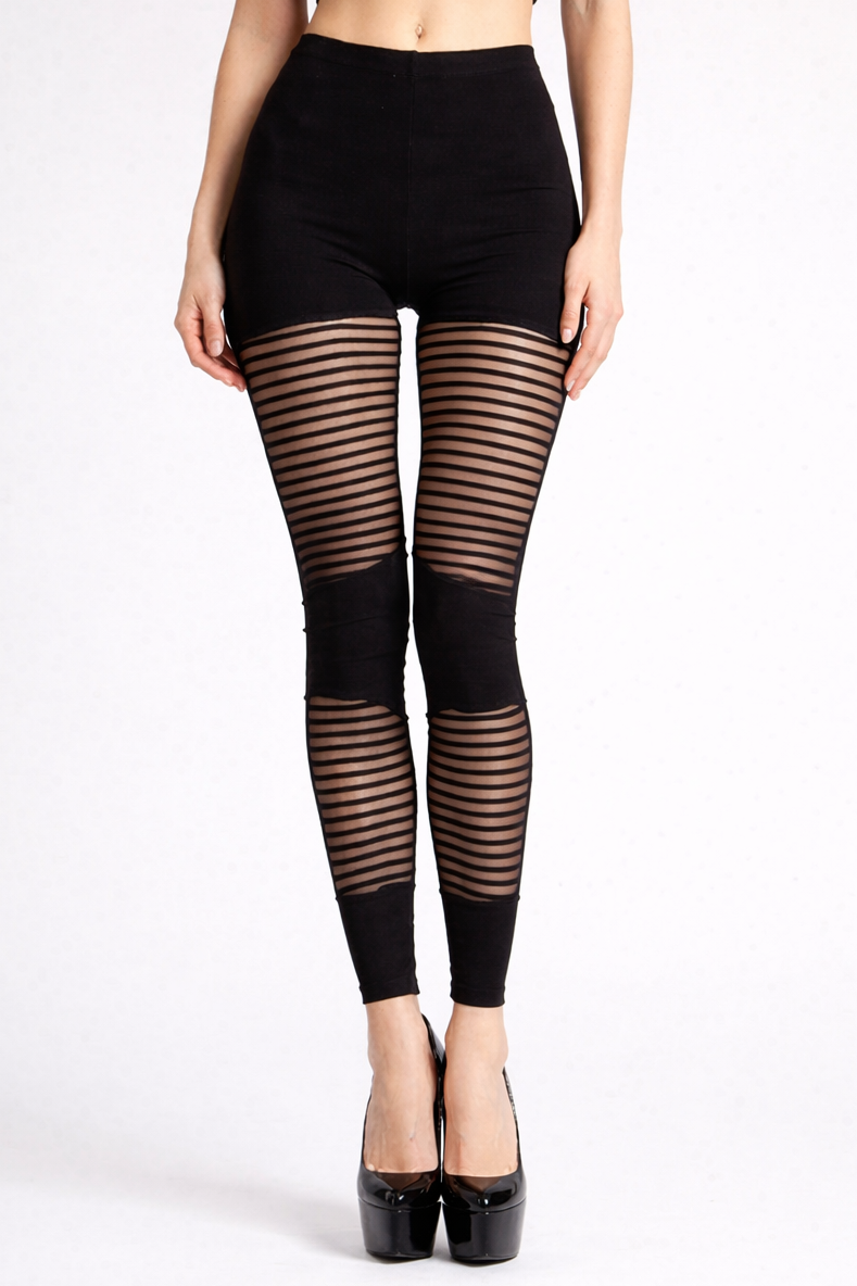 Model standing with legs together wearing high-waisted black leggings with horizontal sheer mesh stripes and very high black patent platform heels against a plain light background.