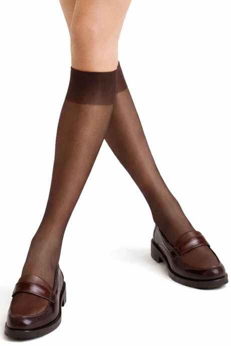 Brown tights worn with brown shoes on a white background