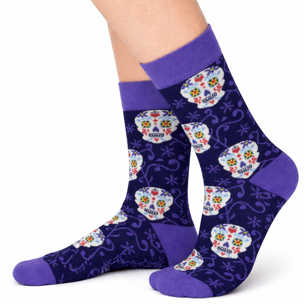 Navy socks with colorful skull designs and purple accents worn by a person on a white background